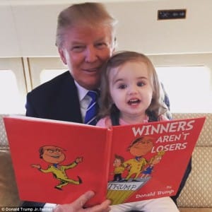 Donald Trump currently the front runner for GOP president reads to his grand-daughter Chloe from that Christmas classic, 'winners aren't lots.' photo by Donald Trump, jr (Chloe's Dad) aboard their car (?) plane (?).