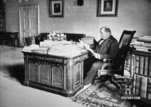 Grover Cleveland sits at the Resolute desk, c 1896